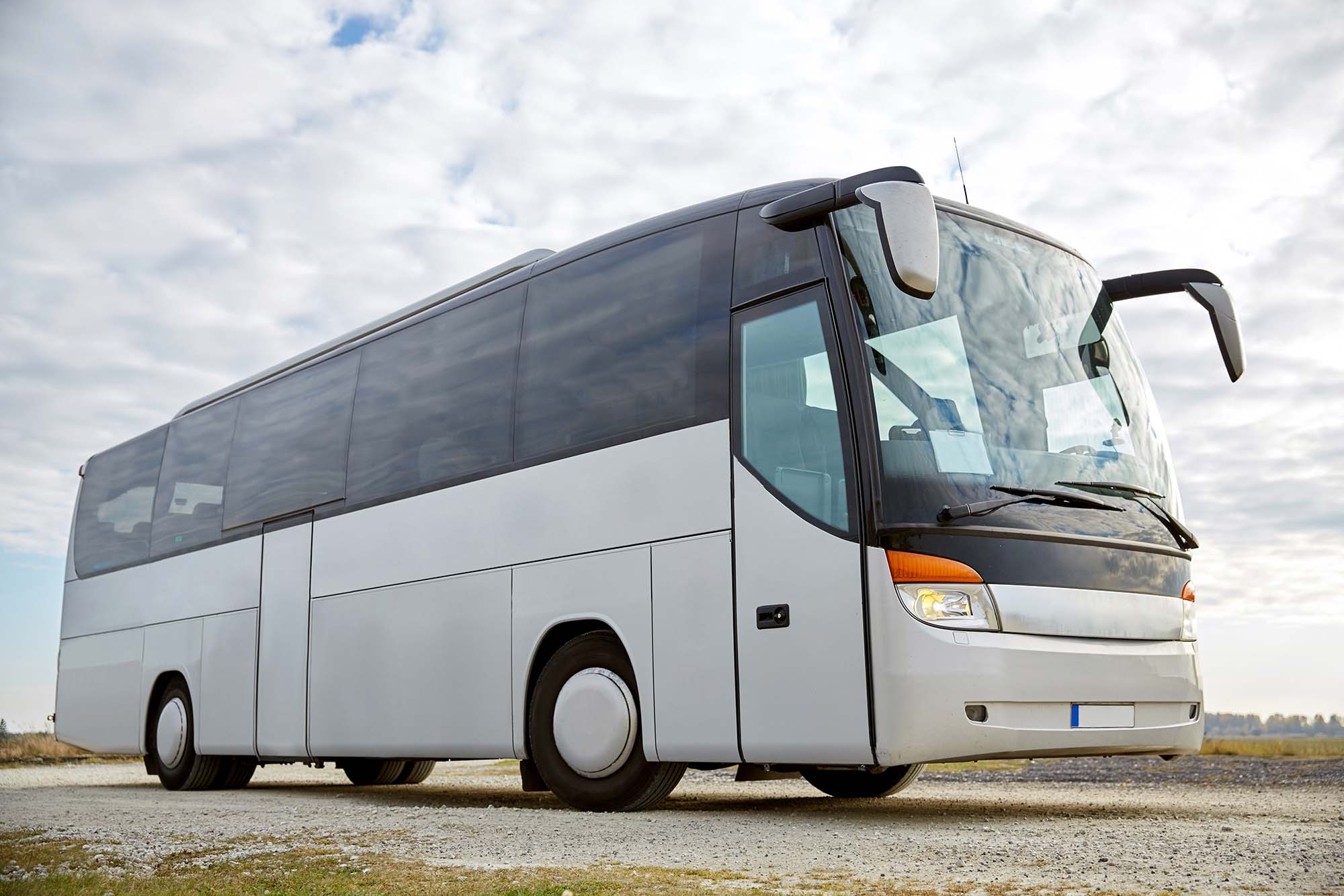 travel, tourism, road trip and passenger transport - tour bus parked outdoors; Shutterstock ID 339800600; search_id: search_id; customer_id: customer_id; geo_location: geo_location; number_viewed: number_viewed