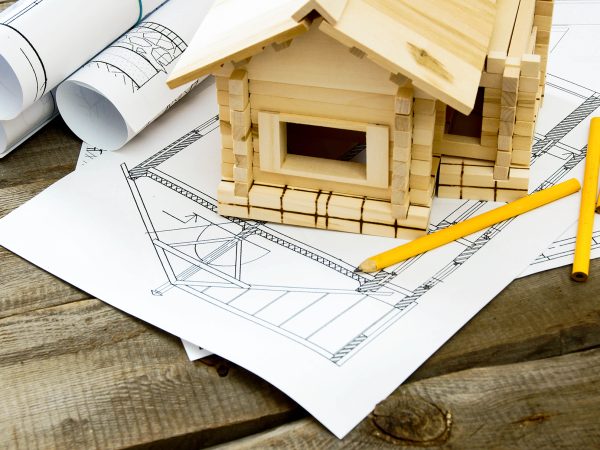 Building house. House construction. Many drawings for building and small wooden house on old wooden background.; Shutterstock ID 263323367; search_id: search_id; customer_id: customer_id; geo_location: geo_location; number_viewed: number_viewed